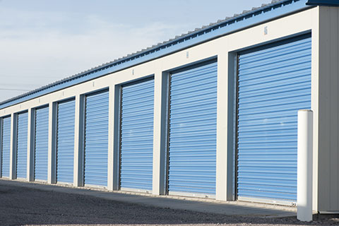 Large commercial storage units with blue doors.