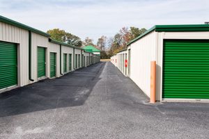 Residential storage units with green doors.