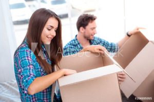 man and woman packing moving boxes