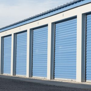 Large self storage units with blue doors.