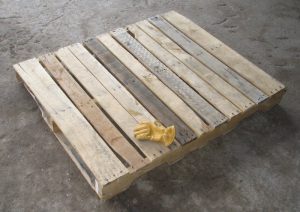 Wooden Pallet for rental unit with glove on top